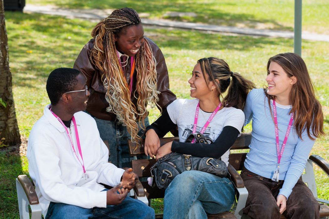 group-of-students-talking-on-bench-2026